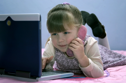 girl on phone and laptop